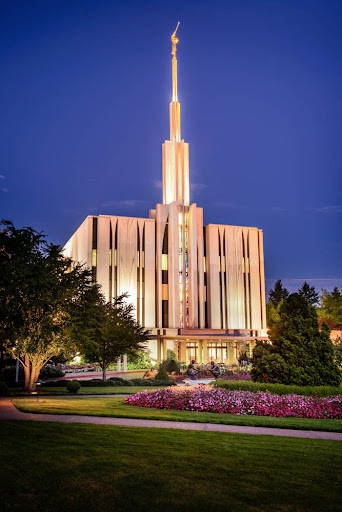 Seattle Temple glowing against a deep blue evening sky