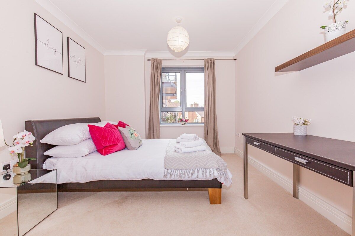 Bedroom with large double bed and table