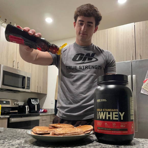 customer shows him cooking with optimum protein