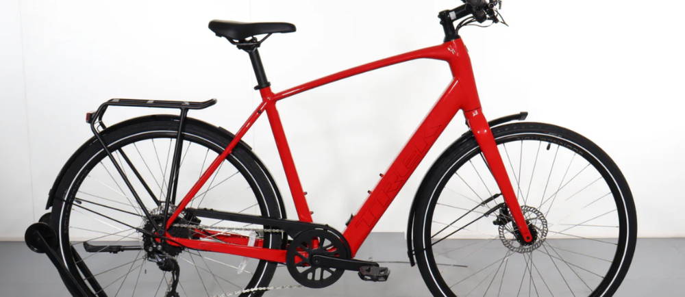 a red Trek FX+2 electric city bike