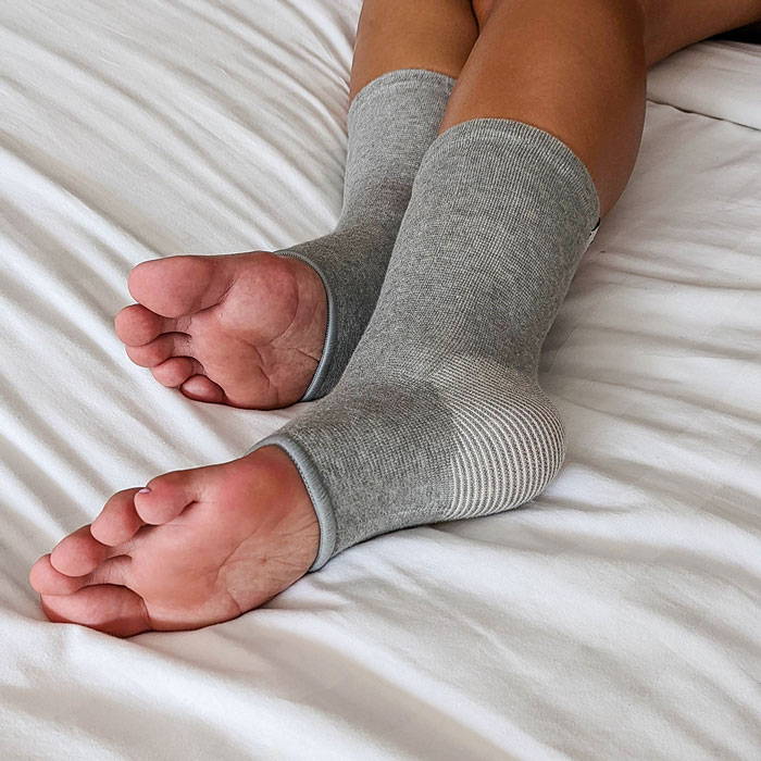 relieve foot pains, onecompress bamboo footsleeves, sad woman