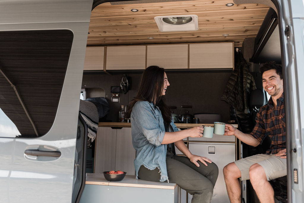 Rack & Roll - Sprinter 144 Van Conversion - Woman and Children Enjoy View from Lofted Bed - The Vansmith