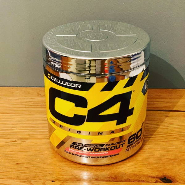 athlete shows his bottle of cellucor pre workout
