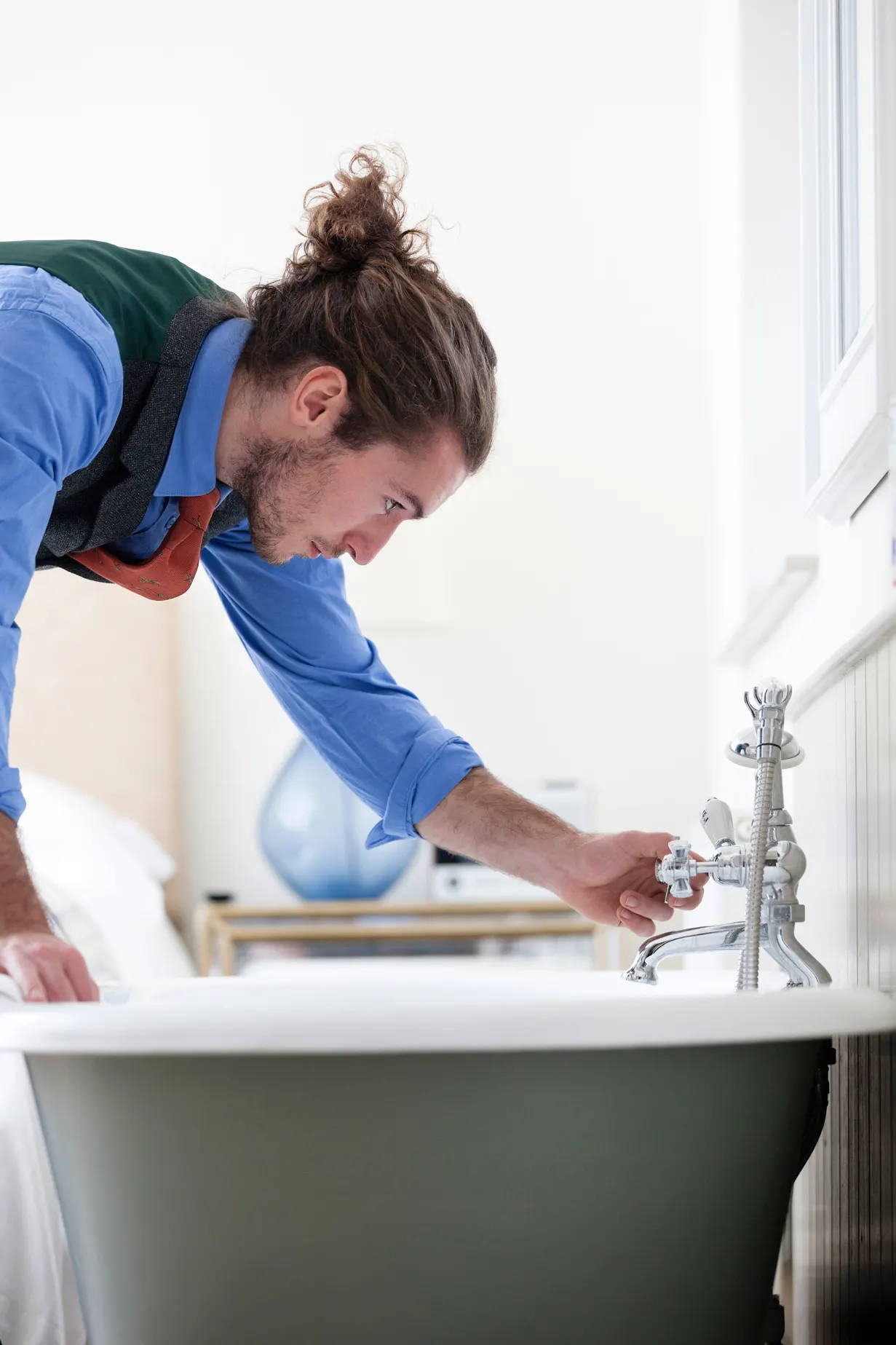 Shirt, tie and waistcoat all regent. Running a bath.