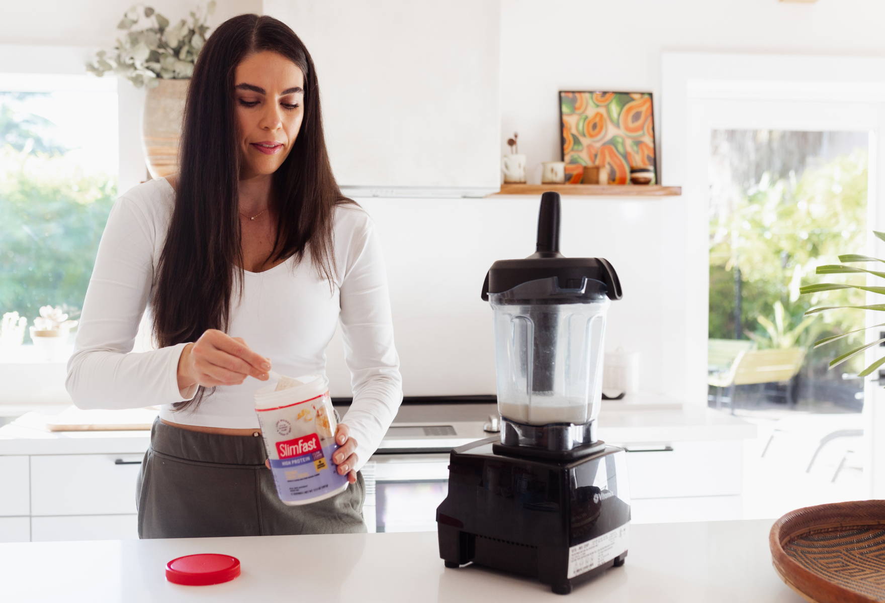 Lifestyle image of lady making a smoothie