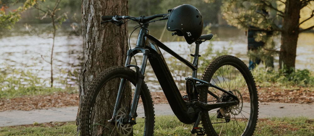 Giant electric mountain bike next to tree