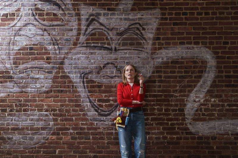Image may contain: Julianne Moore, Clothing, Pants, Jeans, Brick, Face, Head, Person, Photography, Portrait, and Teen