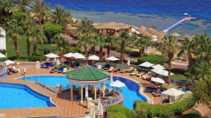 Beautiful sea view with swimming pool and beach in tropical luxury resort hotel on Red Sea beach in Sharm el Sheikh, Egypt.