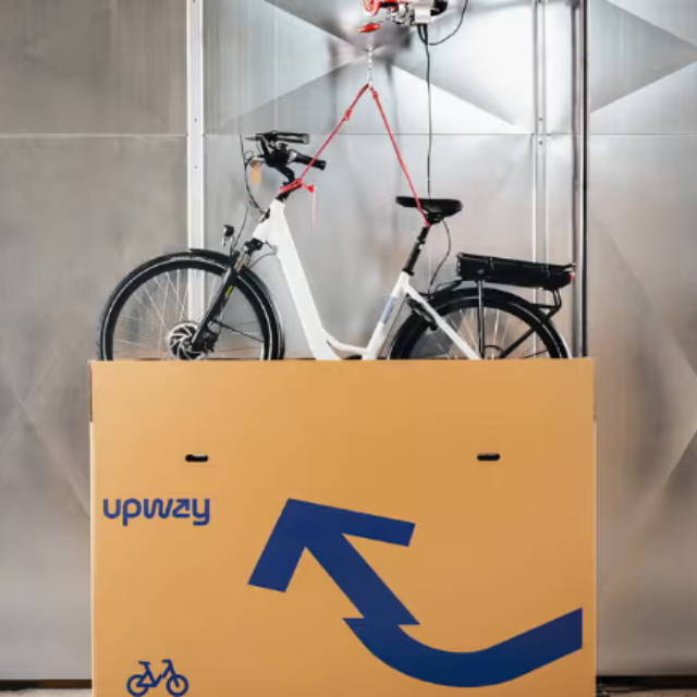 Upway bike lowered into shipping box