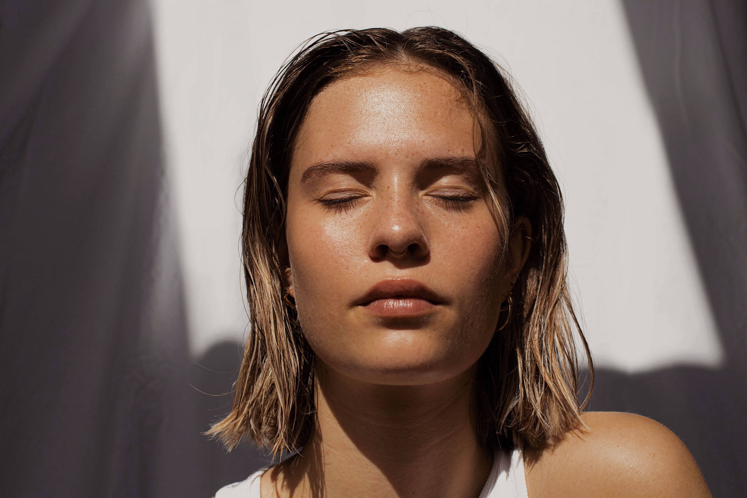 Woman with clear glowing skin enjoying the sun