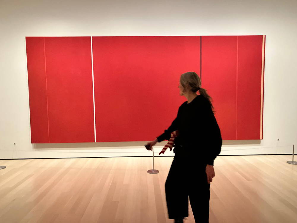 Jo at MOMA in front of a red artwork