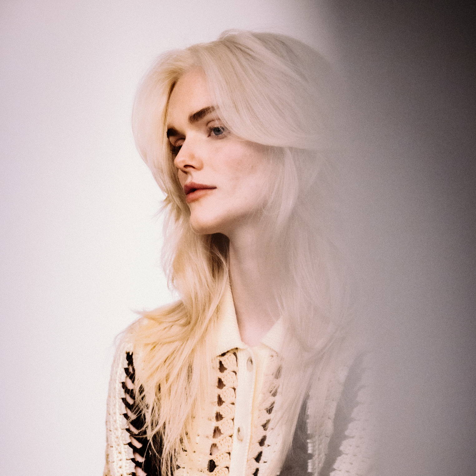 blonde woman with fluffy butterfly hairstyle