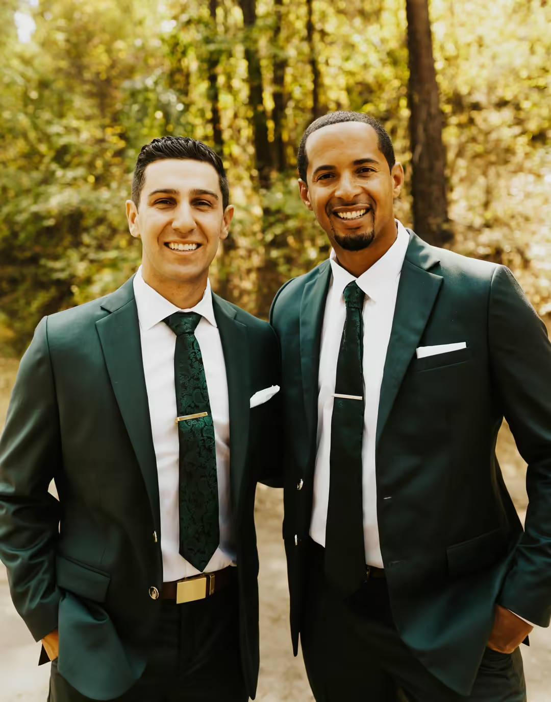 groomsmen posing in green suits