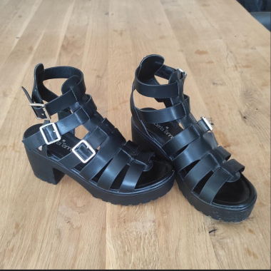 Black platform sandals with silver buckles