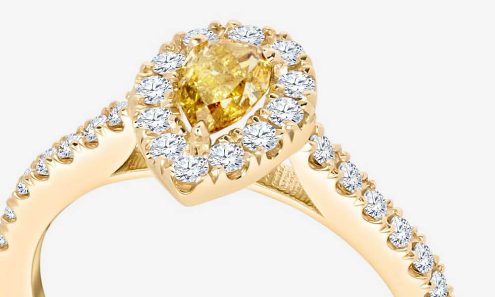 pavé setting on a halo ring with pear-shaped yellow diamond