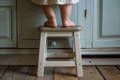 Kid next to the step stool.