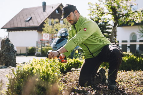 Mitarbeiter von Francesco`s Hausmeisterservice in Kempten bei der Pflege von Beeten und Grünanlagen rund um ein Wohngebäude
