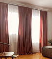 beautiful blush velvet curtains with white sheer curtains behind them, in a bedroom with hardwood floor