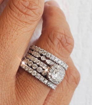 Four band engagement stack hugging a cushion cut diamond engagement ring