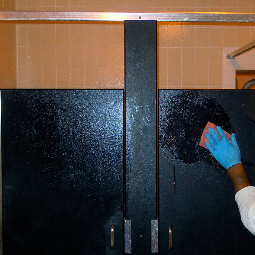 removing graffiti from bathroom stalls using graffiti safewipes