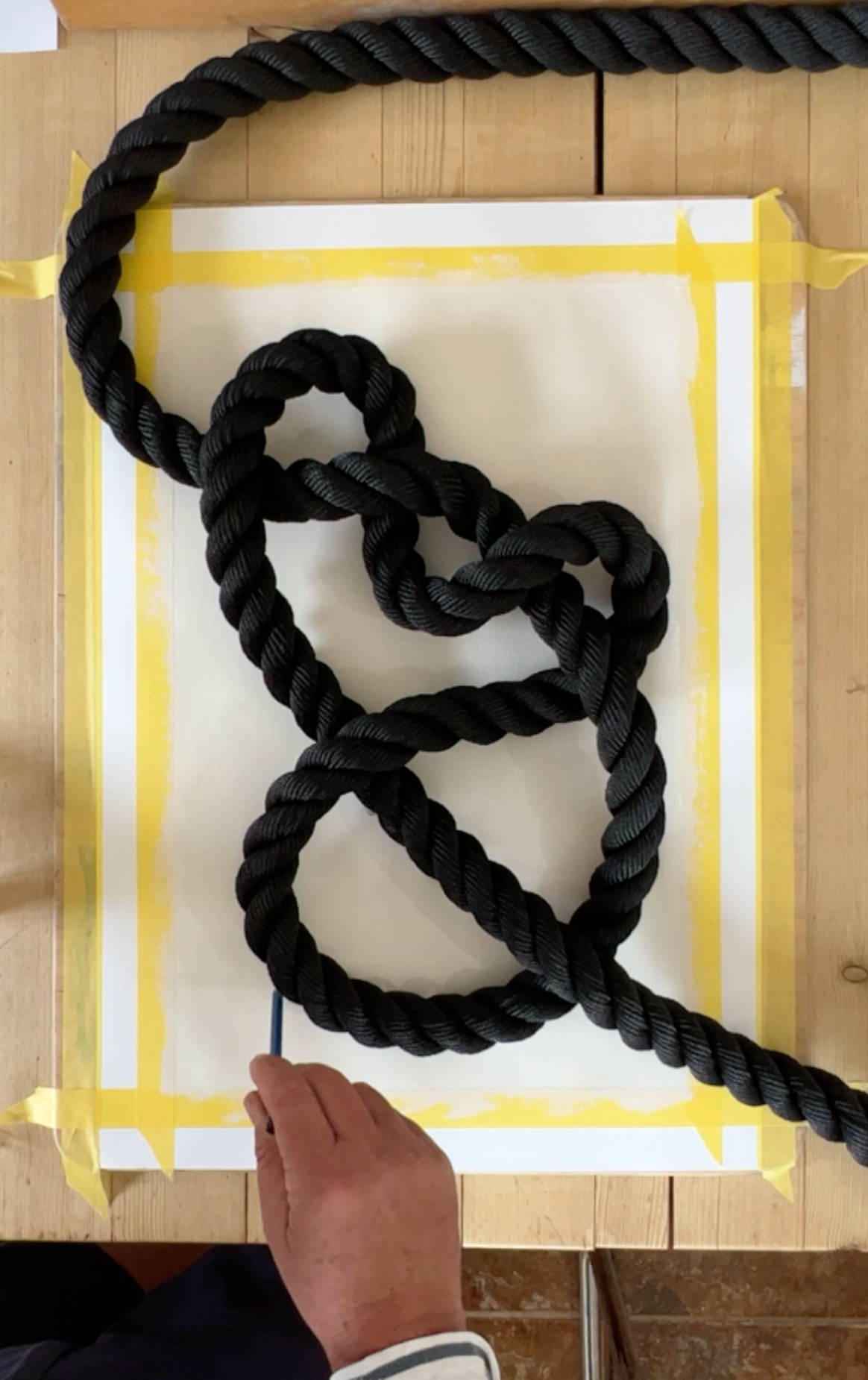 using nautical rope to paint abstract blue line art