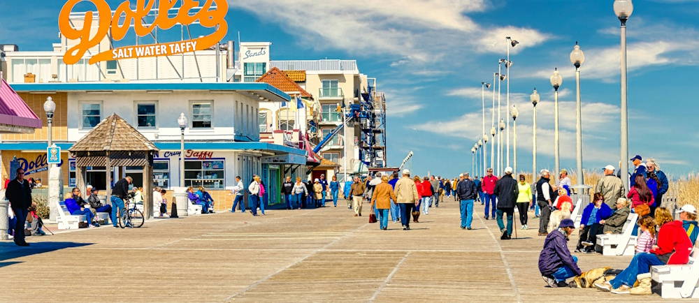 Photo by <a href="https://unsplash.com/@mrgeecee?utm_source=unsplash&utm_medium=referral&utm_content=creditCopyText">Gary Cole</a> on <a href="https://unsplash.com/photos/a-group-of-people-walking-on-a-boardwalk-next-to-a-building-hNgFCbQZ1ZE?utm_source=unsplash&utm_medium=referral&utm_content=creditCopyText">Unsplash</a>       