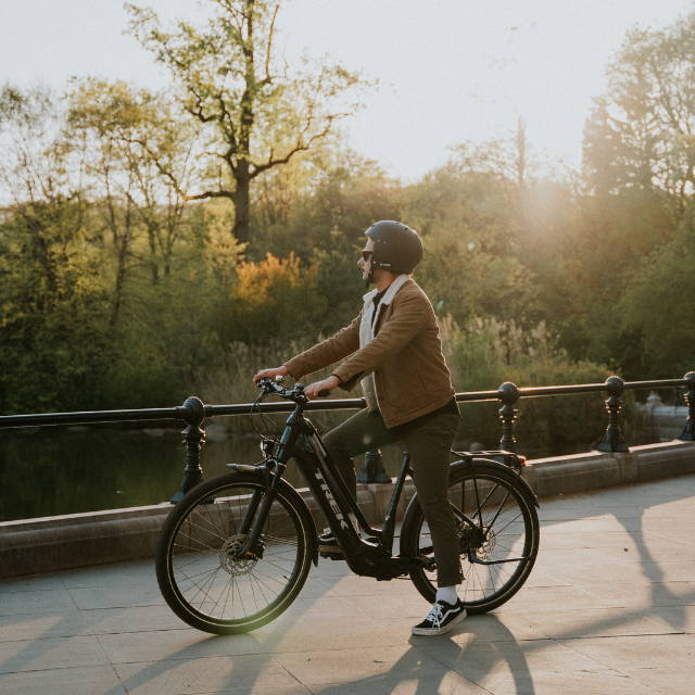 A man sitting on an E-Bike in a park