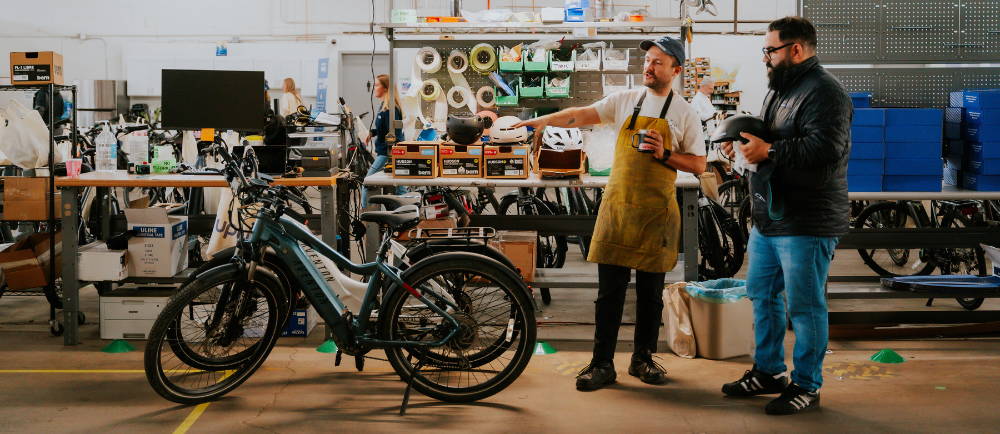 Upway UpCenter technician and customer with electric bikes