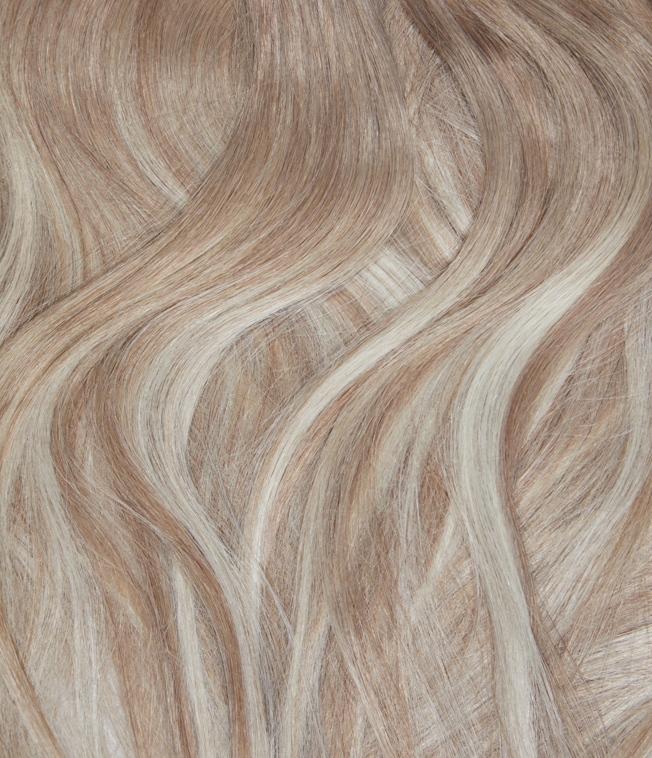 A close-up of blonde hair with highlights. There is a contrast between the lighter blonde and darker blonde strands, giving a multi-tonal effect to the hair.
