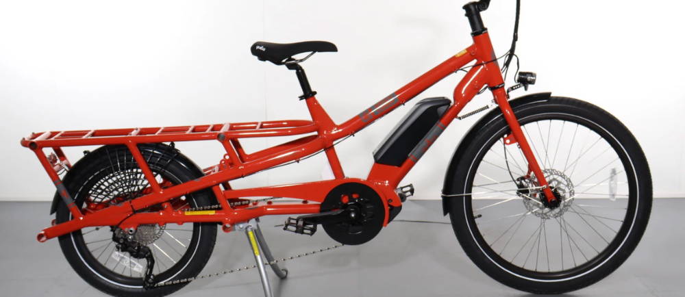 a red Yuba Spicy Curry electric cargo bike