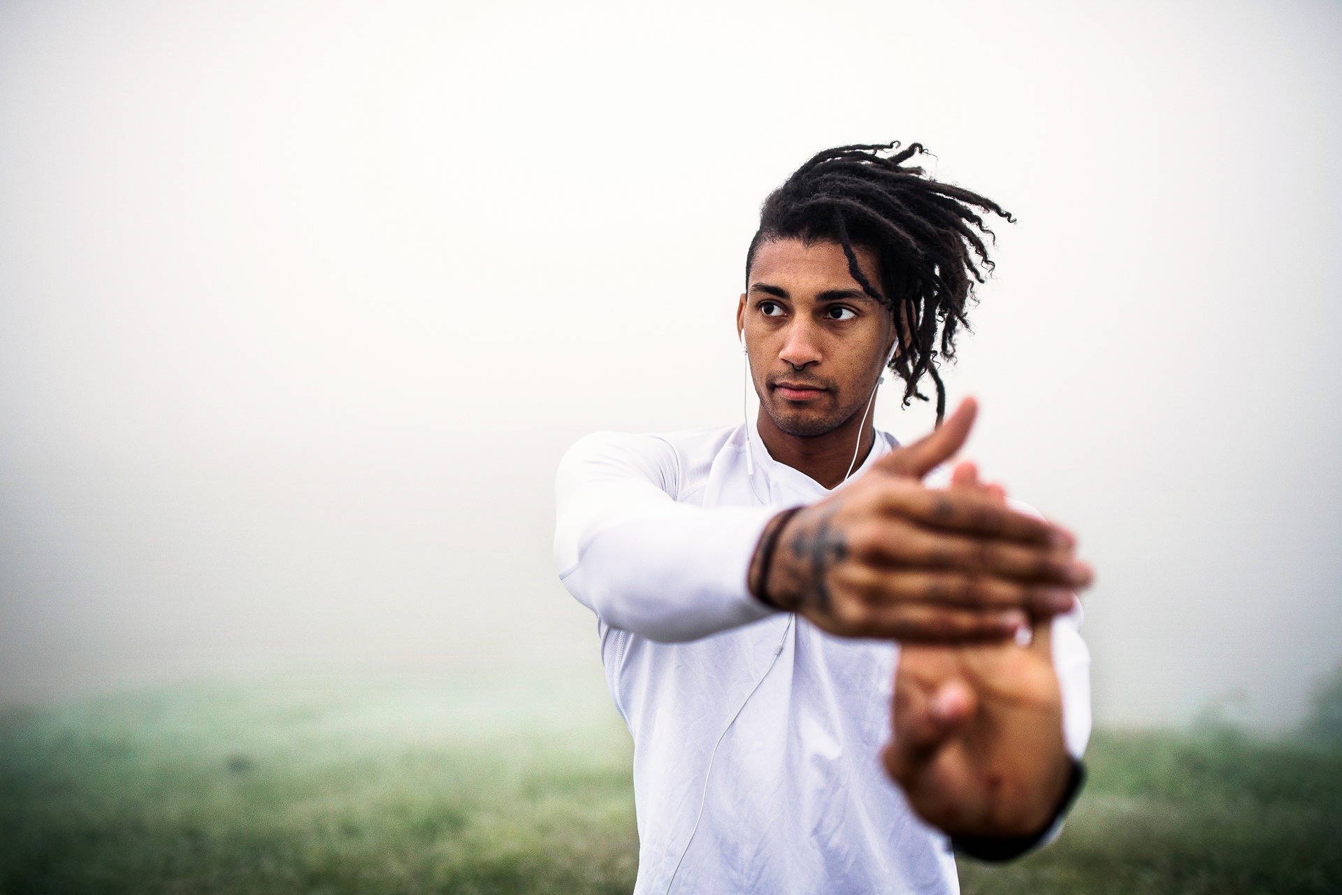 Young man stretching his arm 