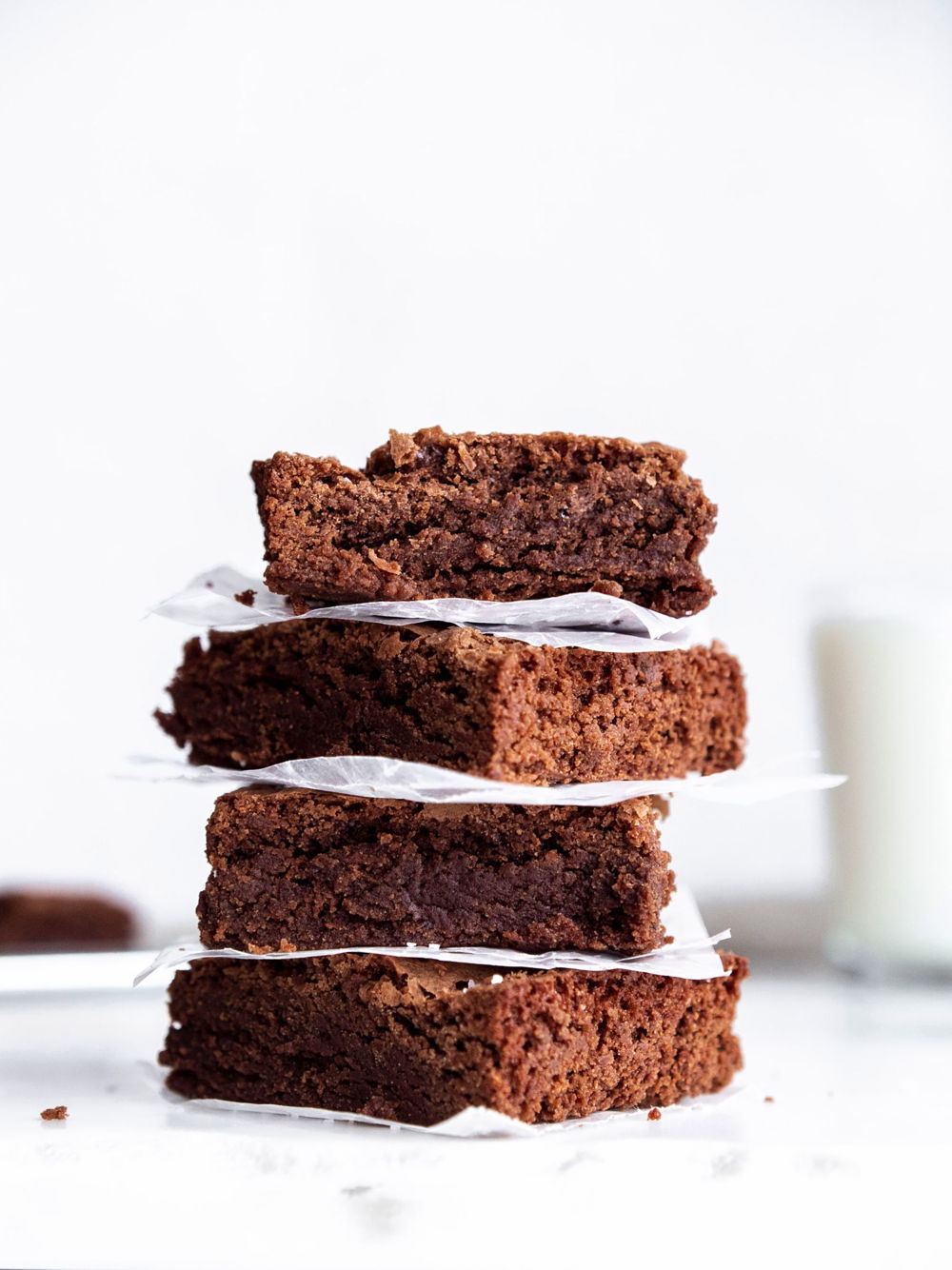 A closer view from the side of a stack of chewy brownies