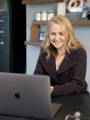Woman consulting her personalized GenoPalate DNA diet plan on a computer with registered dietitian