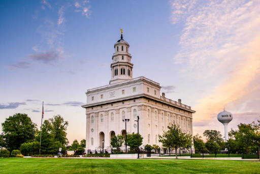 Nauvoo Temple surrounded by green grass and trees.