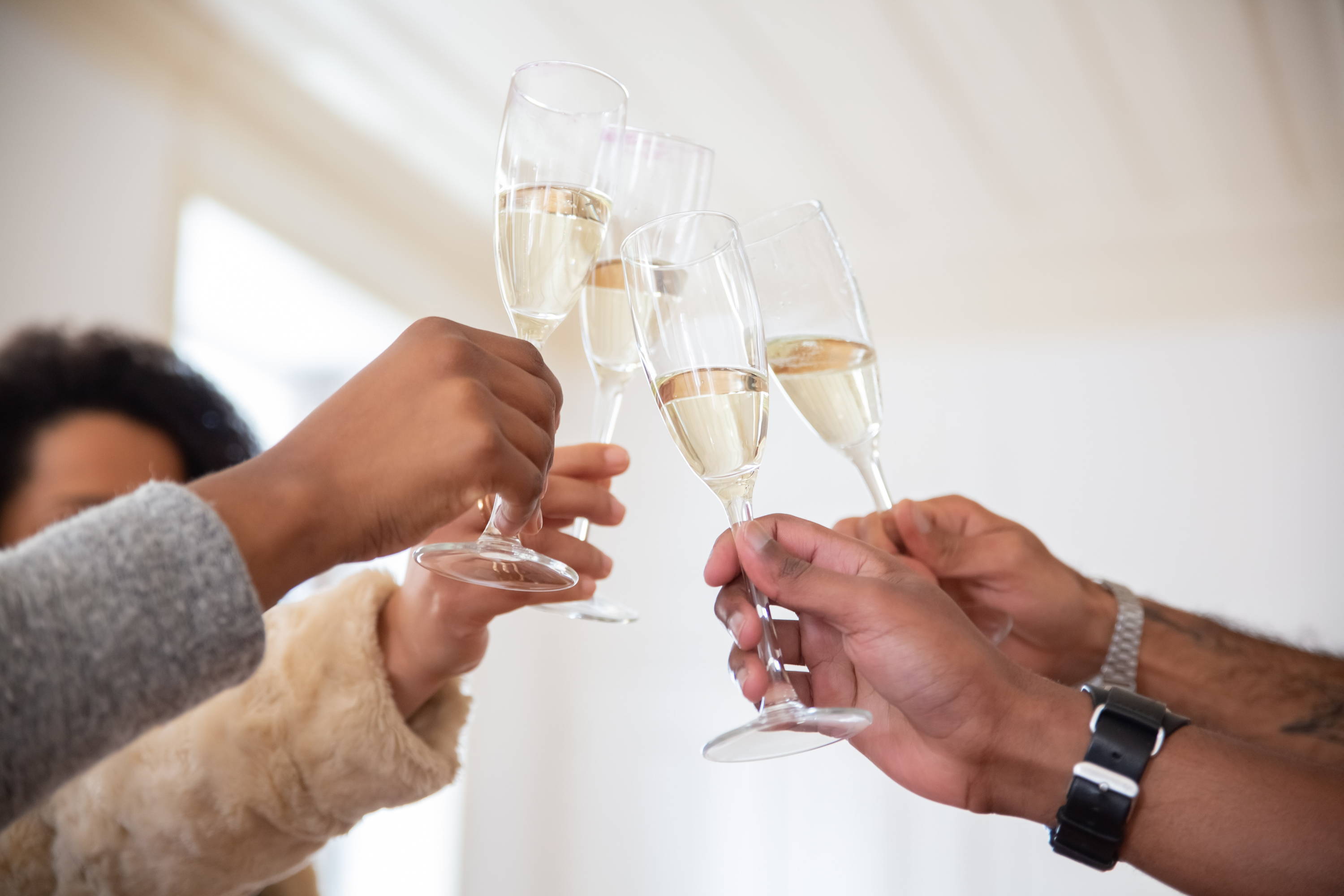 Celebratory toast with champagne glasses to understand the meaning behind elegant wine.