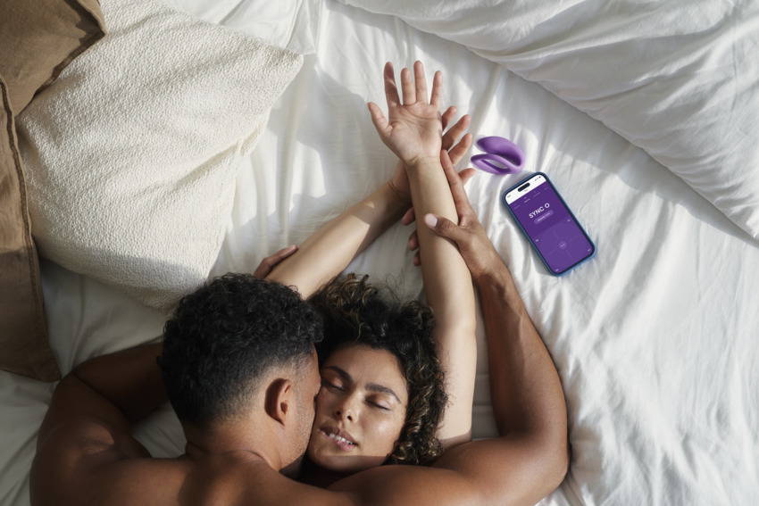 We-Vibe Sync O with Couple on Bed