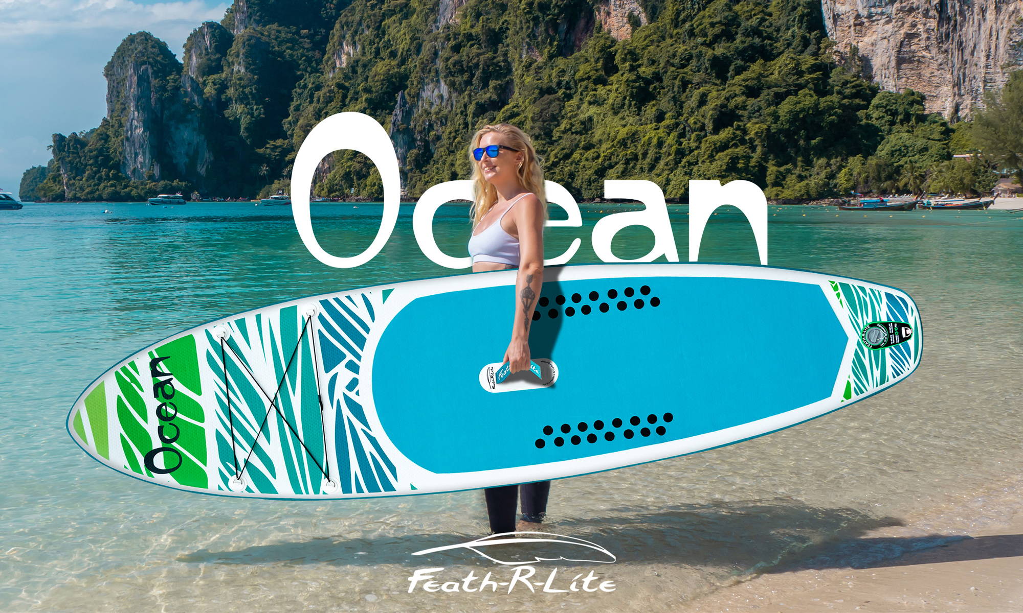 This woman is holding a Feath-r-lite inflatable stand up paddle board with standing in the water