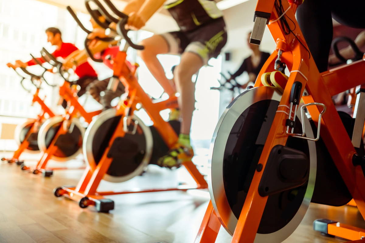 athletes at gym training on bikes