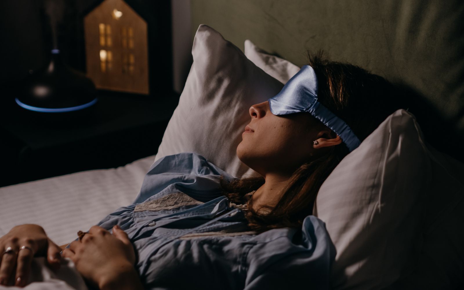 Woman wearing  silk sleep mask & sleeping