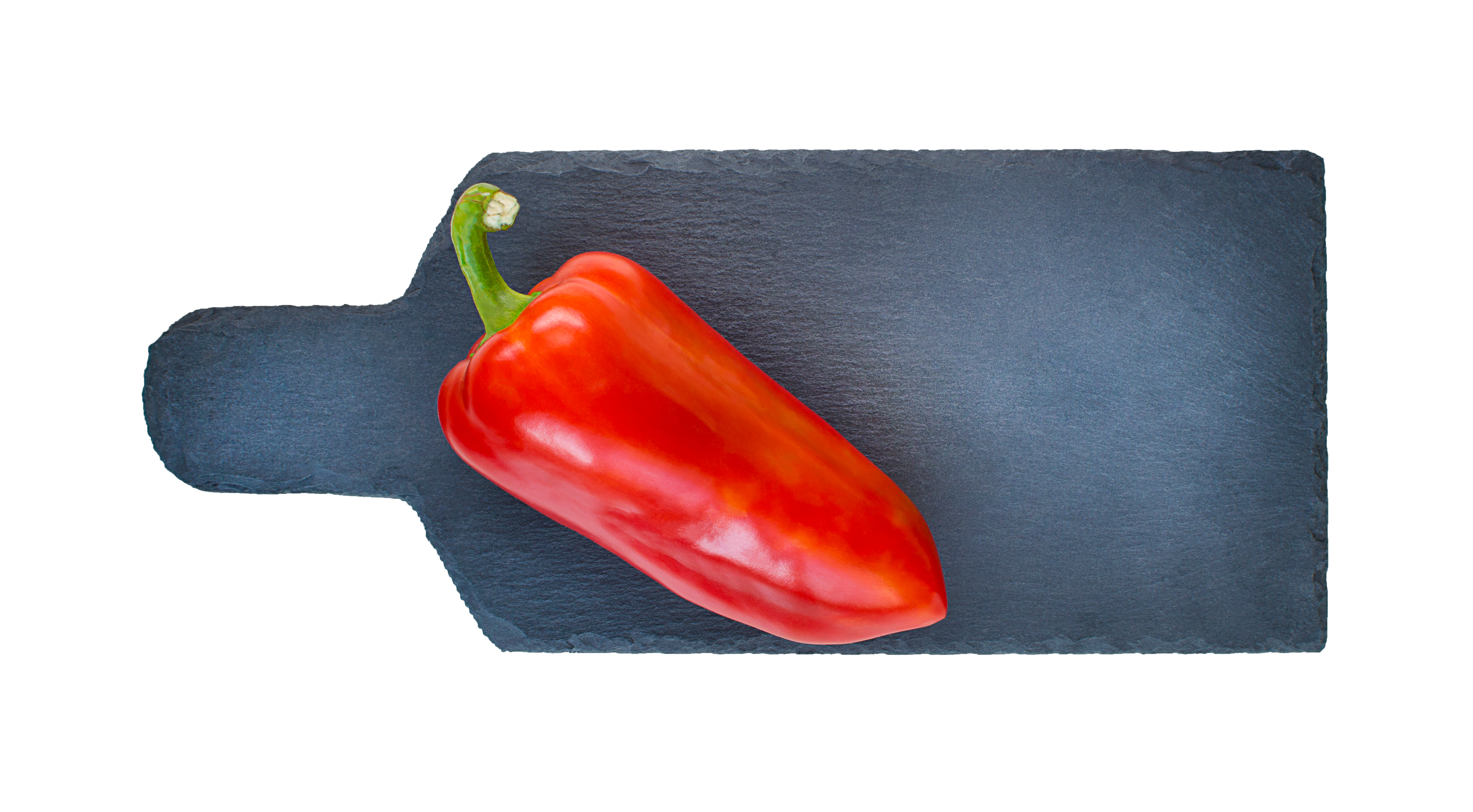 A red corno di toro pepper on a slate cutting board
