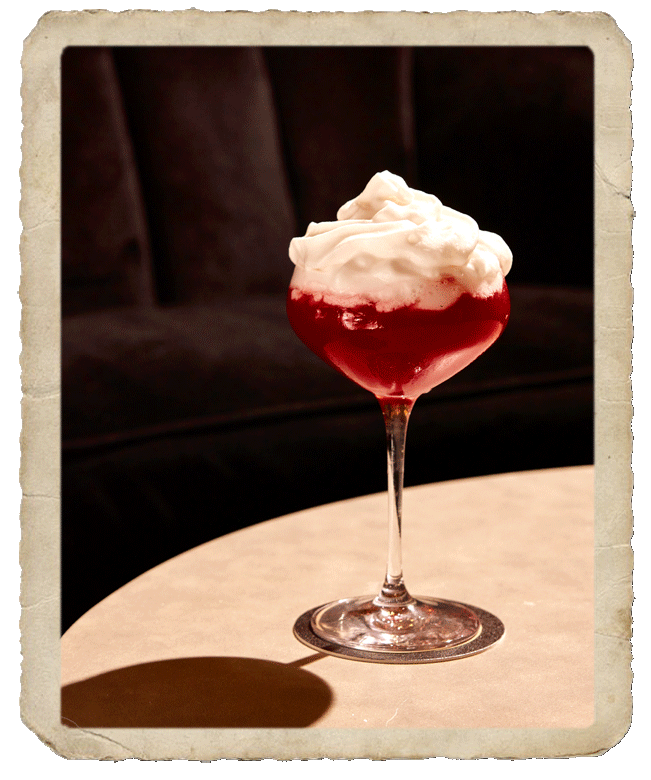 Prepared glass with dark red colored cocktail.