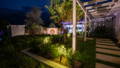 Garden spike lighting highlighting feature planting and landscape elements along the entry pathway, creating depth, contrast and visual interest after dark.