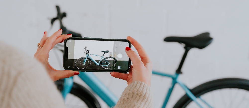 Woman taking a photo of a used electric bike