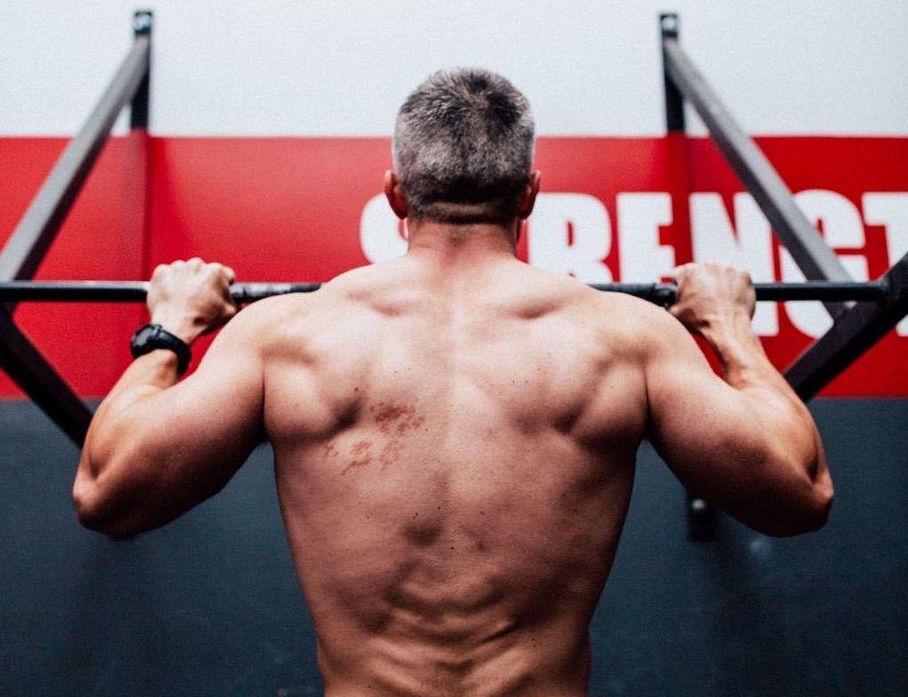 Bodyweight strength training results over 40 - father and daughter showing back development without gym equipment.