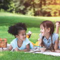 Girls doing crafts on a lawn