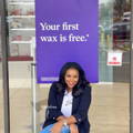 woman sitting in front of a free wax banner