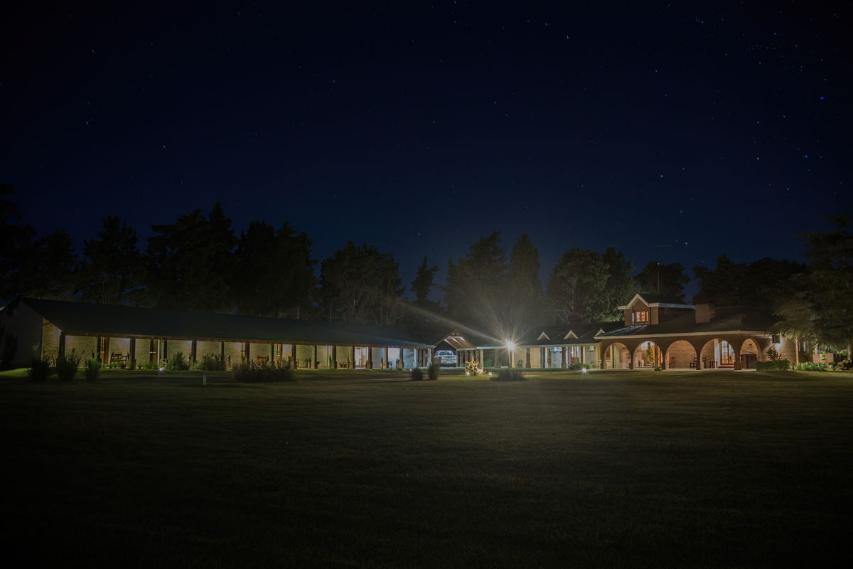 The Estancia Las Palomas lodge lit up at night