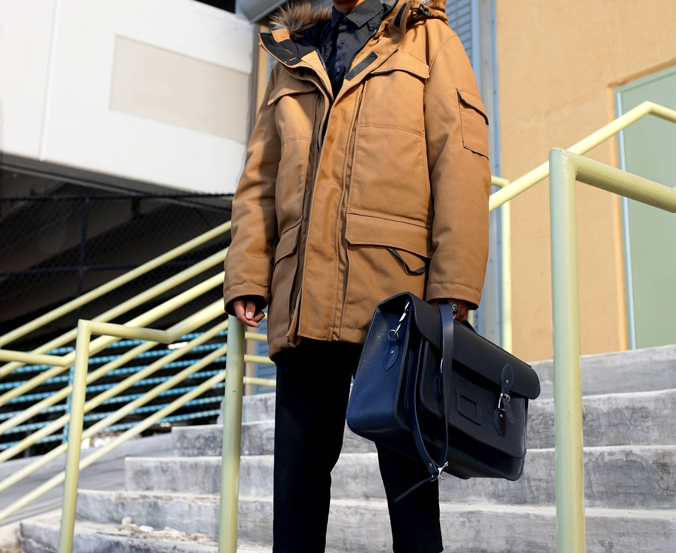 Man Holding Leather Bag