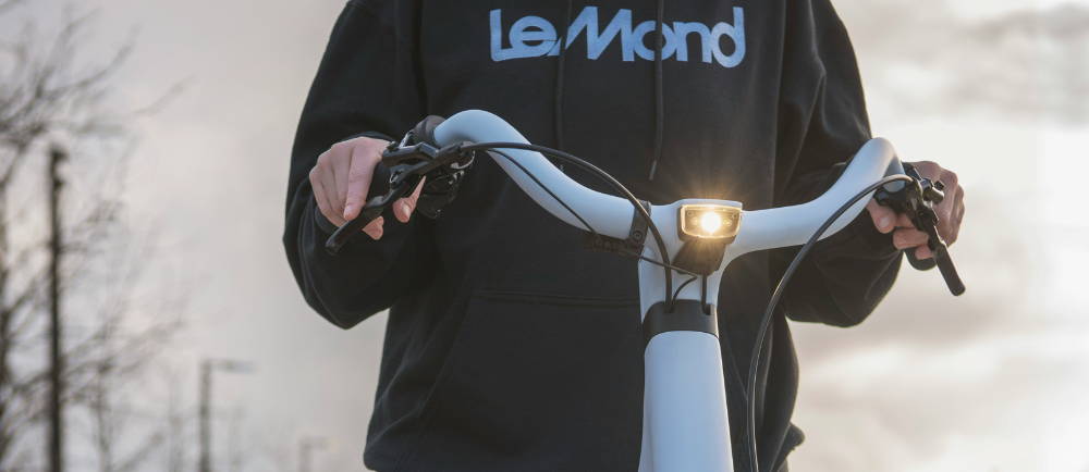 a person on a LeMond e-bike sweatshirt and riding a LeMond bike