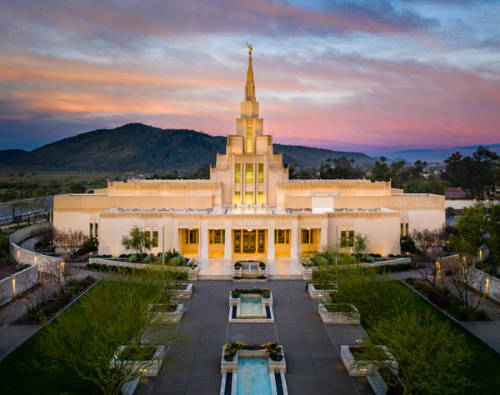 Arial photo of the Phoenix Temple glowing against the evening sky.